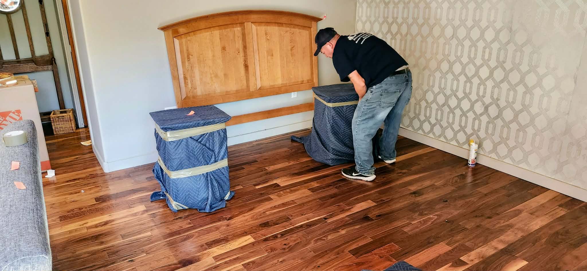 Chris Adams positioning wrapped furniture at a client's new home during a local Seattle move