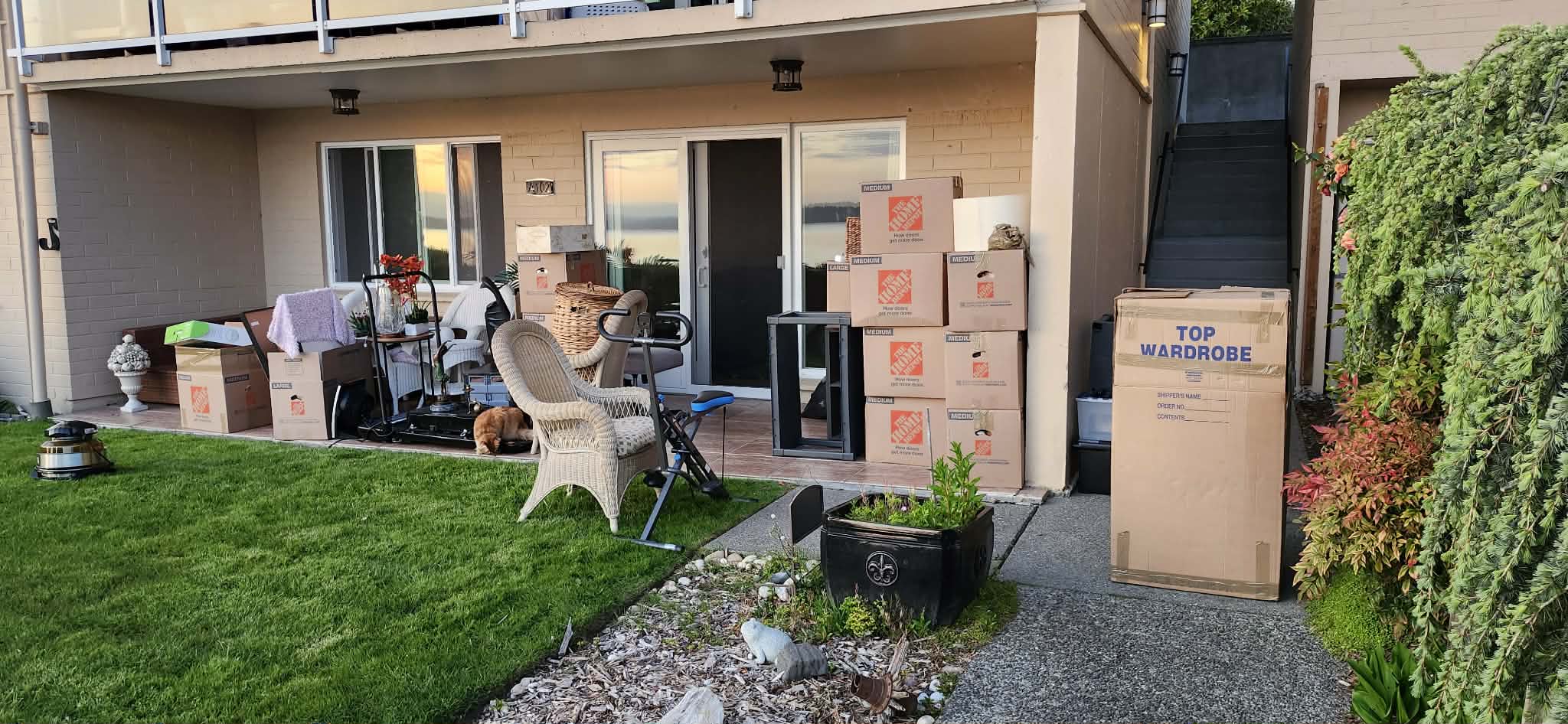 Wardrobe boxes staged on a residential patio ready for loading by Black Crow Moving crew