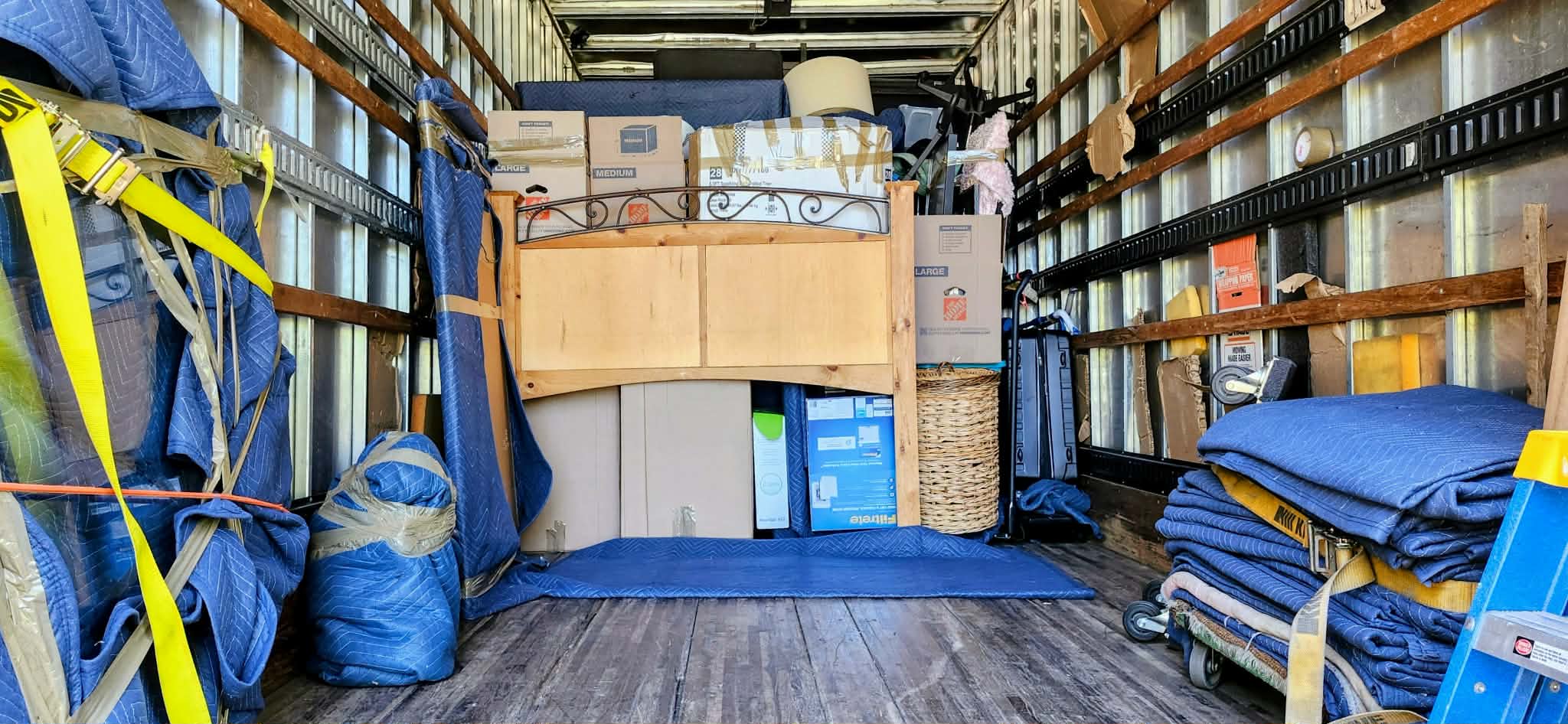 Carefully organized and strapped furniture inside the Black Crow moving truck